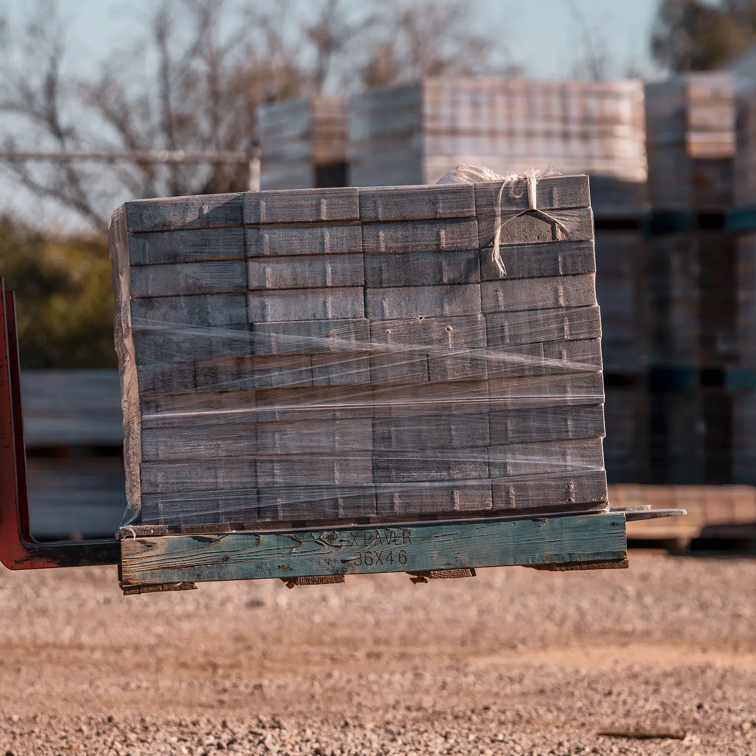 Forklift moving paver pallets at AZ Turf Suppliers yard
