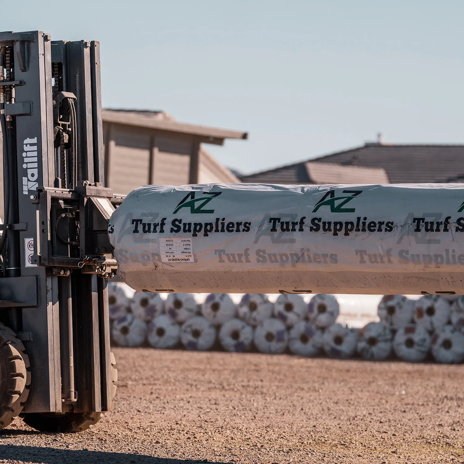 Forklift loading turf rolls at AZ Turf Suppliers yard